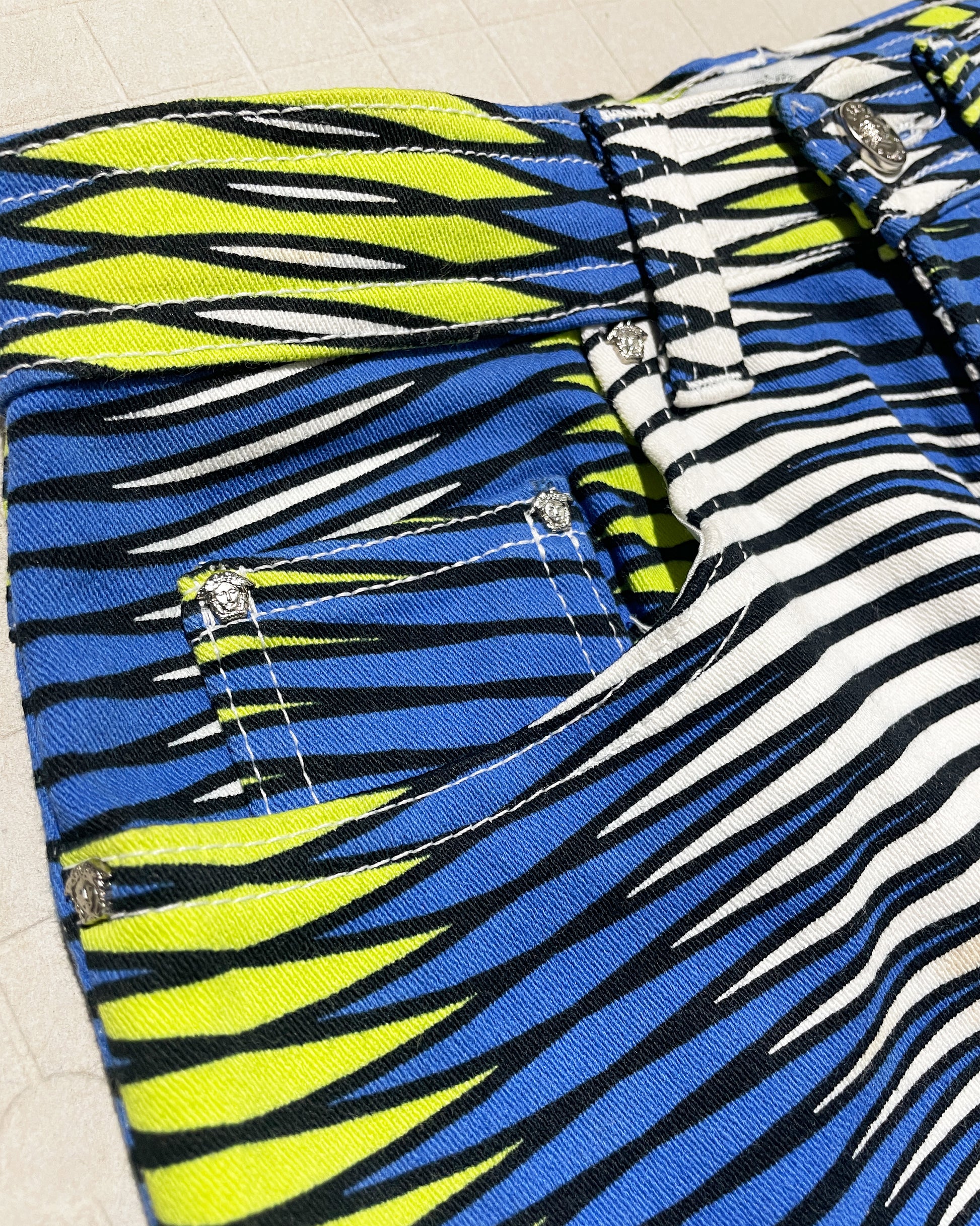 Bold geometric print Versace Jeans Couture trousers with Medusa details